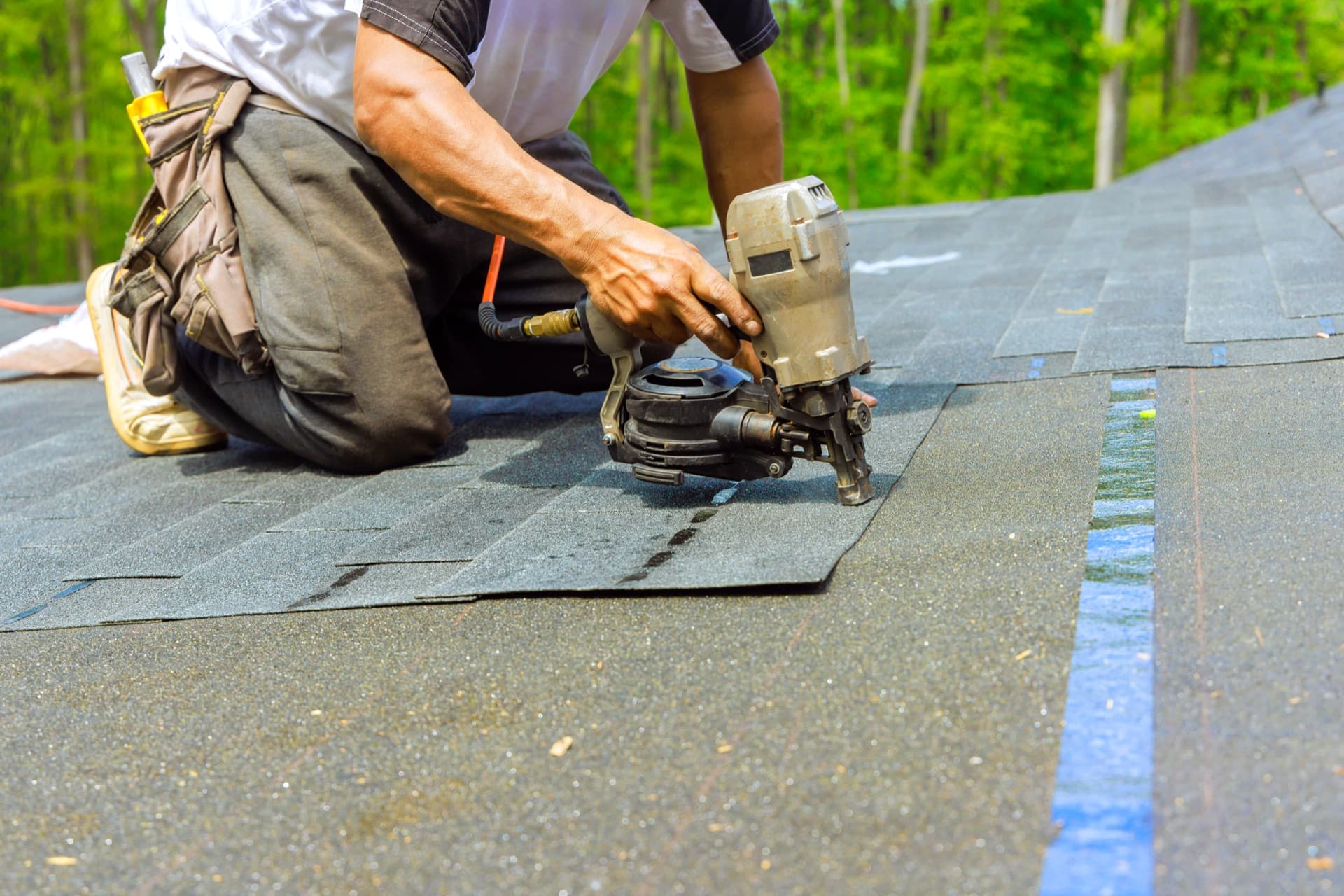 Roofer installing shingles on a Seattle home